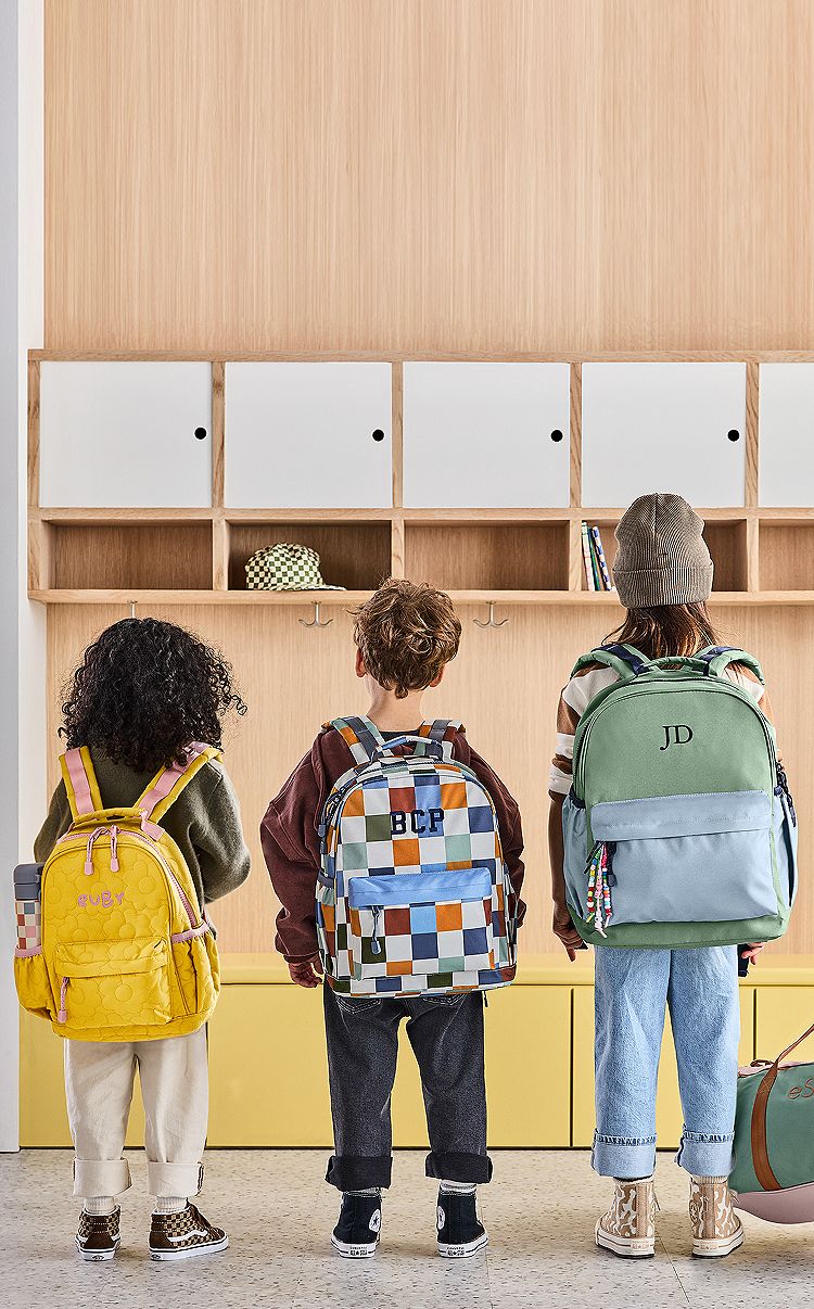 Wybór rozmiaru plecaka dostosowanego do wzrostu dziecka Porównanie trzech plecaków różnych rozmiarów obok linijki mierzącej wysokość